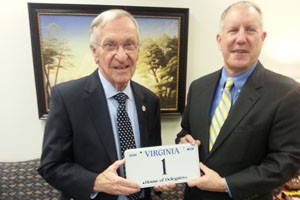Delegate Plum receiving his new "1" license plate from Department of Motor Vehicles Commissioner Richard Holcomb.